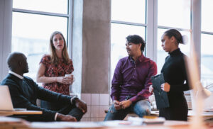 diverse group of young people in an office meeting